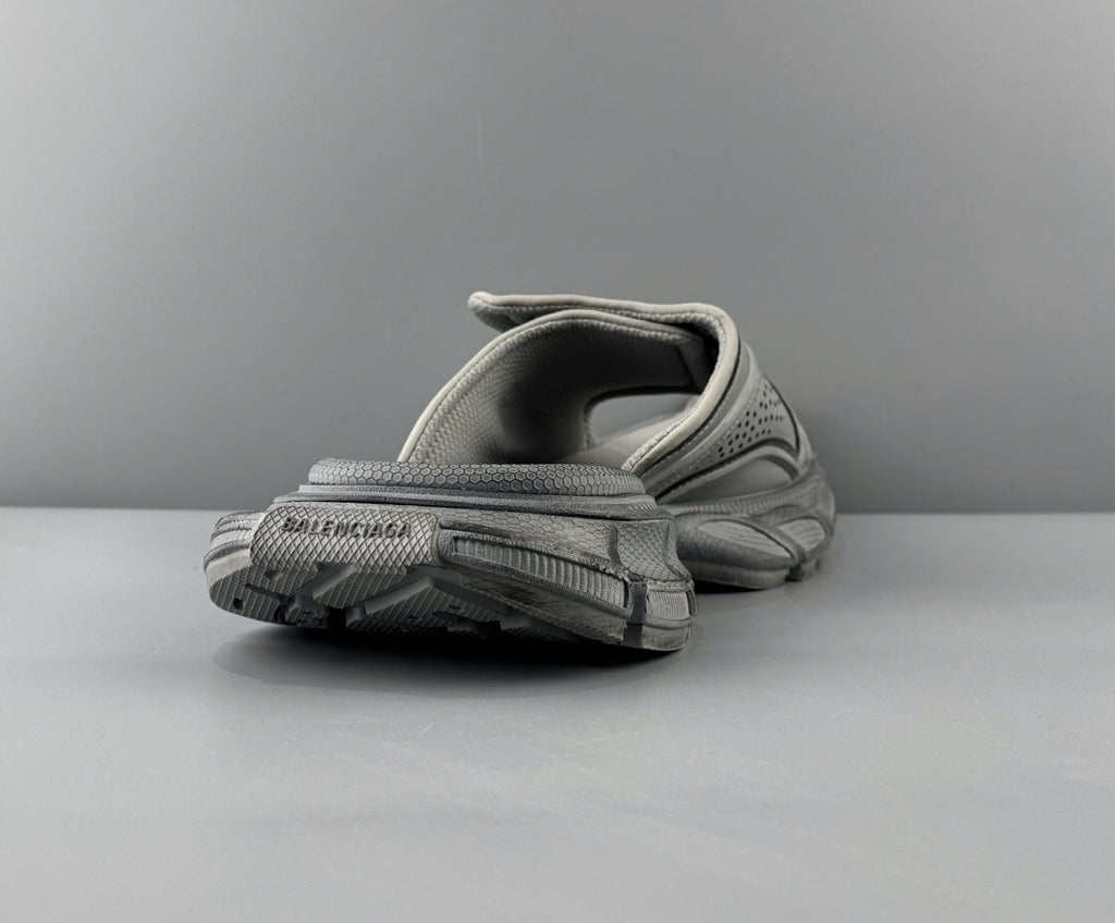 Light gray sandals heel view with textured tread outsole