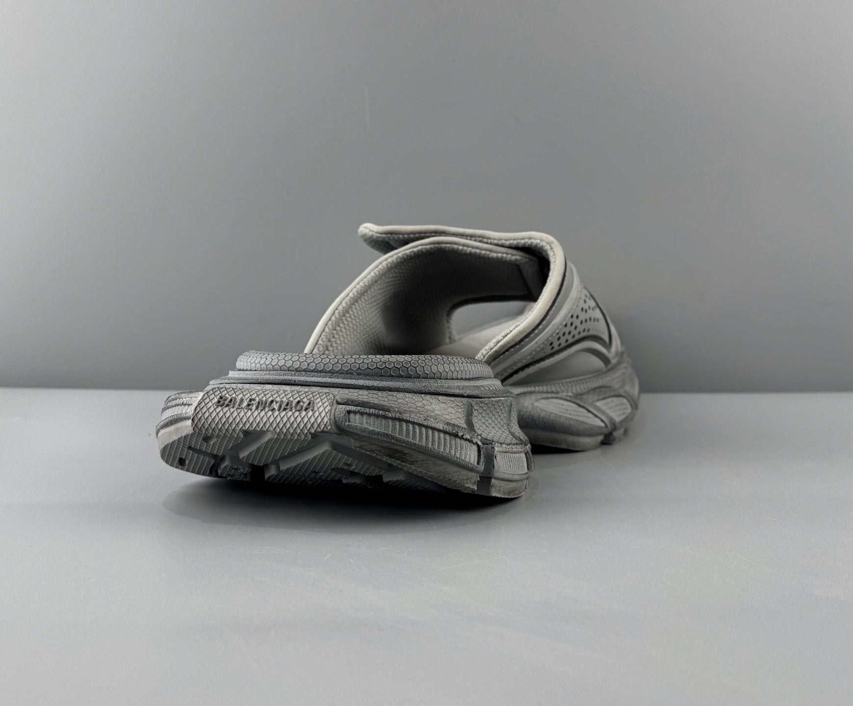 Light gray sandals heel view with textured tread outsole