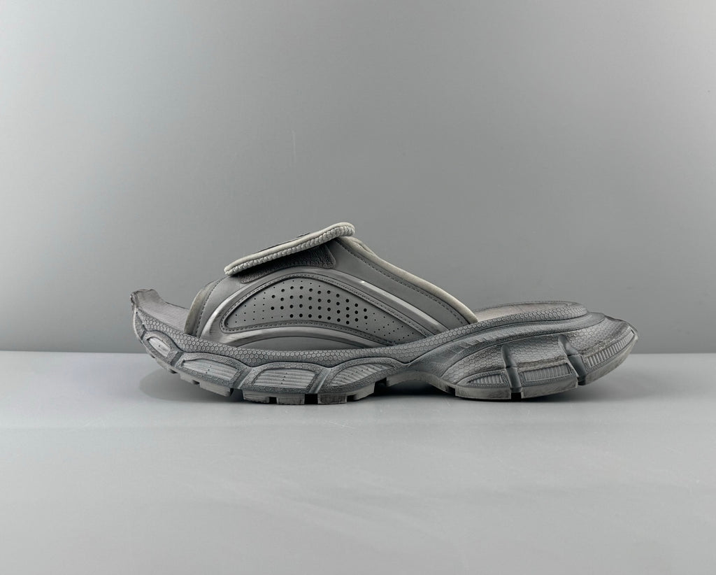 Light gray leather sandals with perforated straps and chunky rubber sole