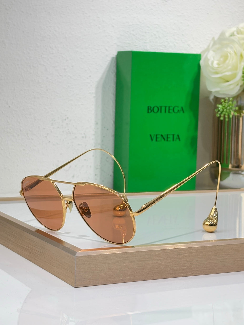 Gold-tone sunglasses with brown lenses and slim metal arms