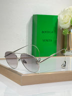 Silver-tone sunglasses with light-gray lenses and thin metal bridge