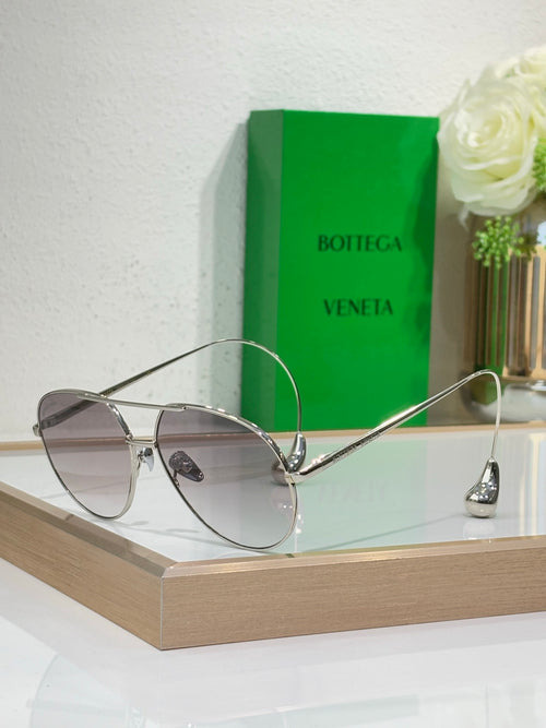 Silver-tone sunglasses with light-gray lenses and thin metal bridge