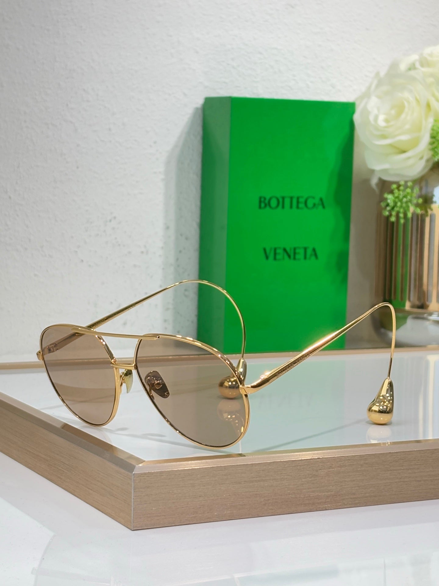 Gold-tone sunglasses with light-tan lenses and slim metal arms