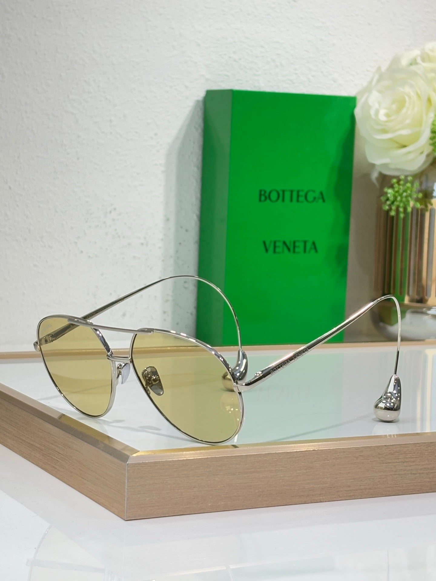 Gold-tone sunglasses with amber-tinted lenses and slim metal arms