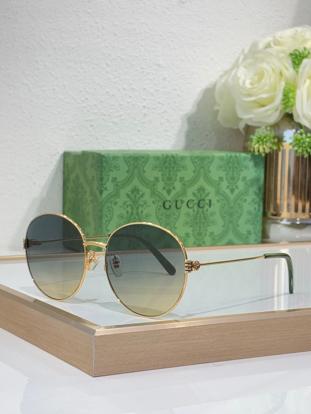 Gucci round sunglasses with gold-tone frame and blue-tinted lenses