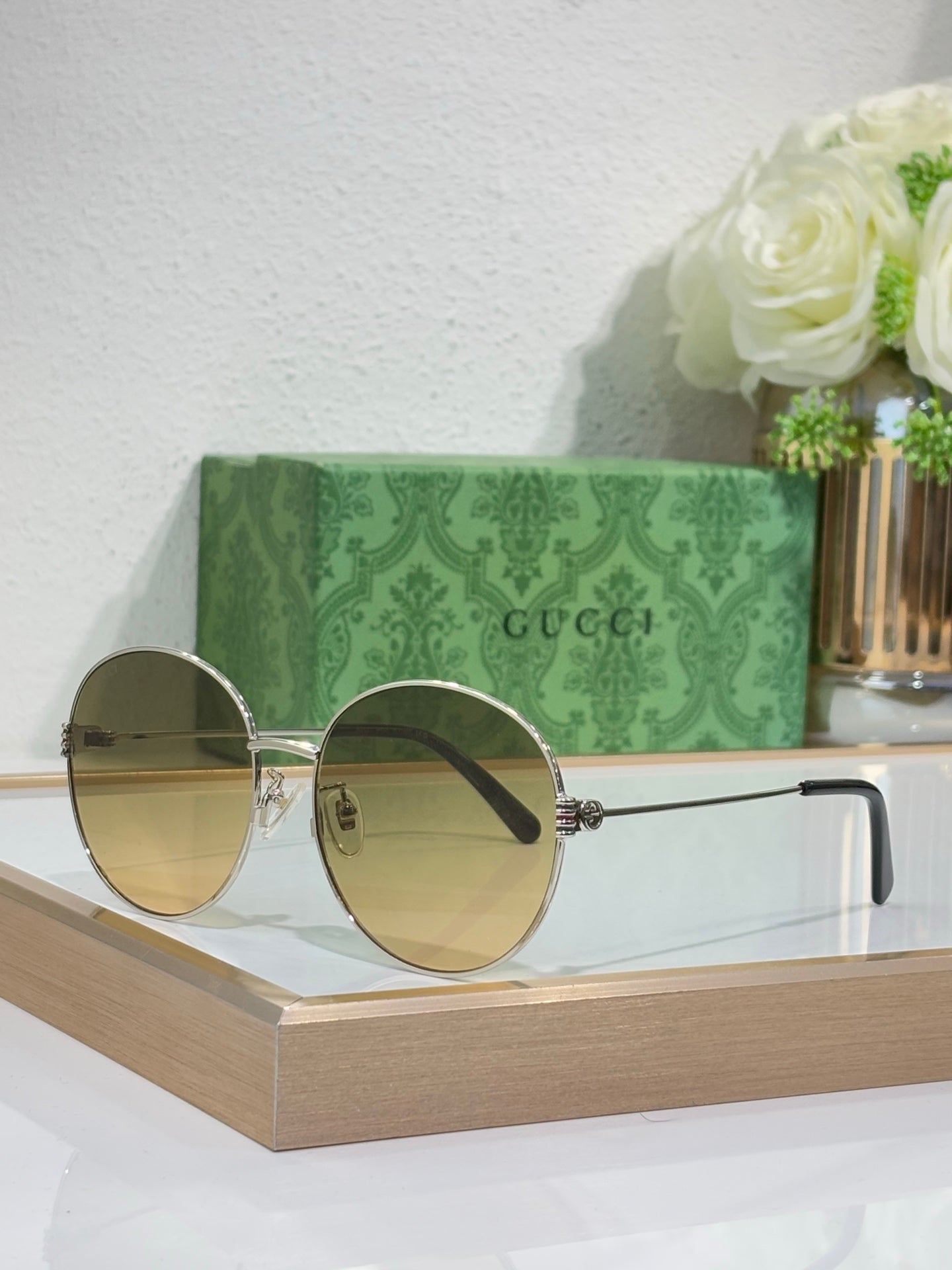 Gucci round sunglasses with gold-tone frame and gradient blue lenses