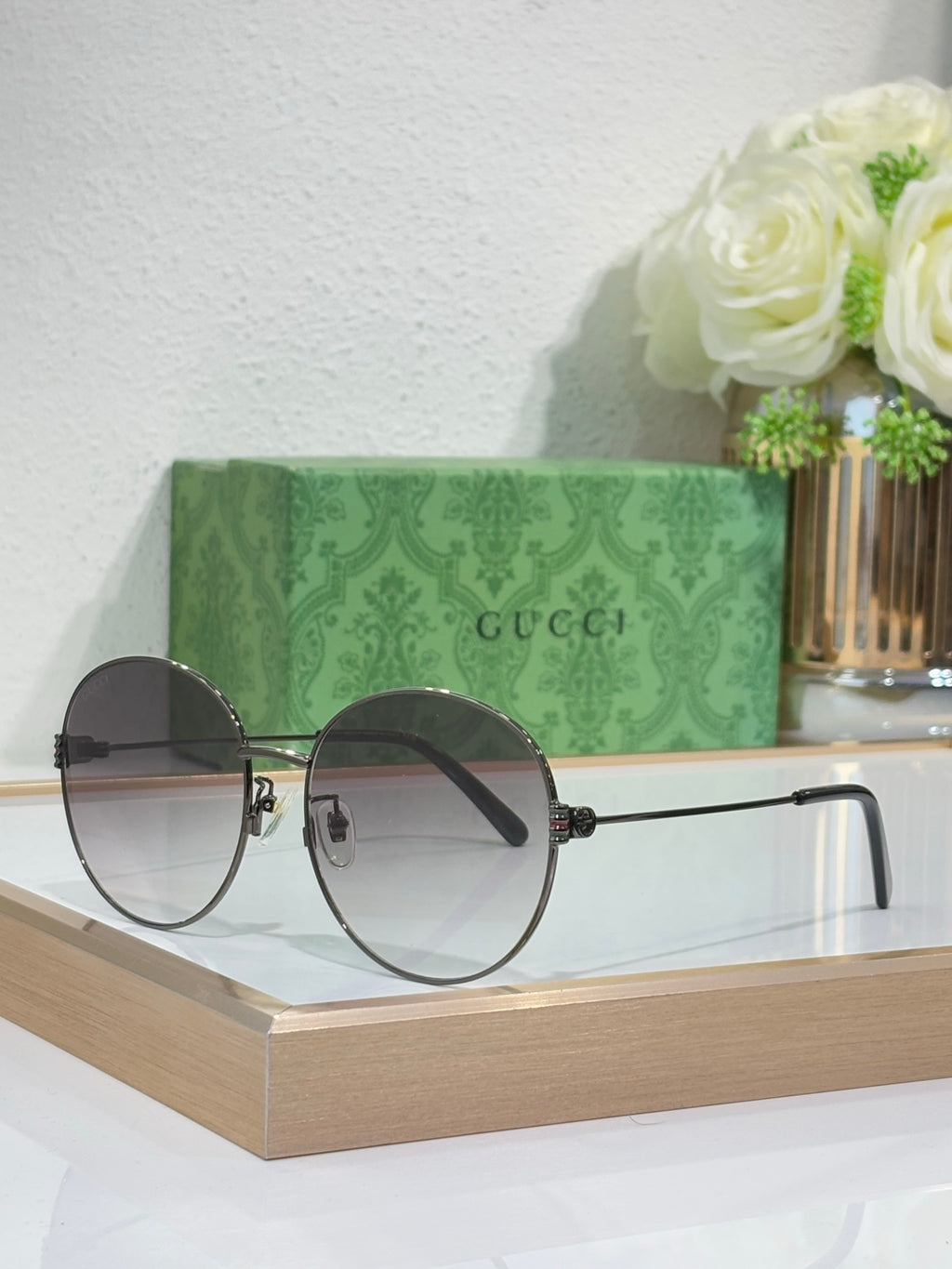 Gucci round sunglasses with gold-tone frame and dark lenses