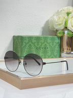 Gucci round sunglasses with gold-tone frame and dark lenses