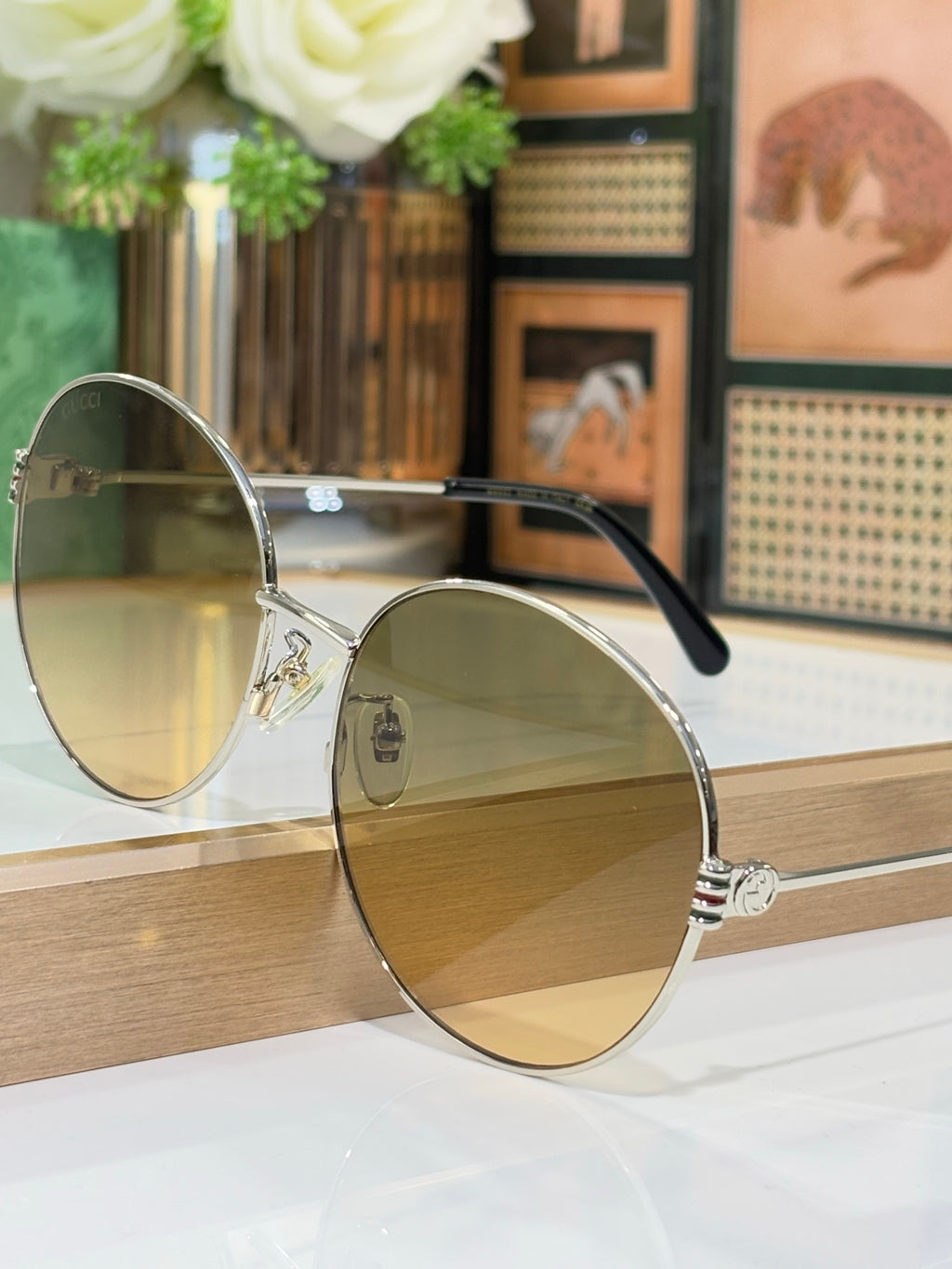 Gucci round sunglasses side view with gold-tone frame and light-tinted lenses