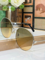 Gucci round sunglasses side view with gold-tone frame and light-tinted lenses