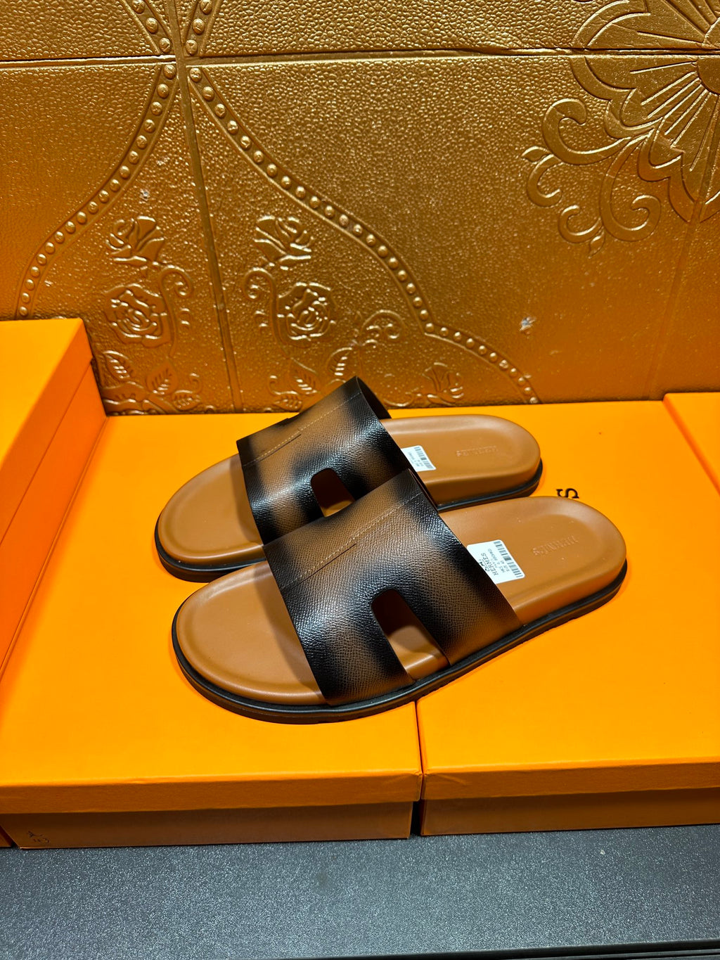 Hermes dark blue leather slide sandals showing top strap detail and footbed
