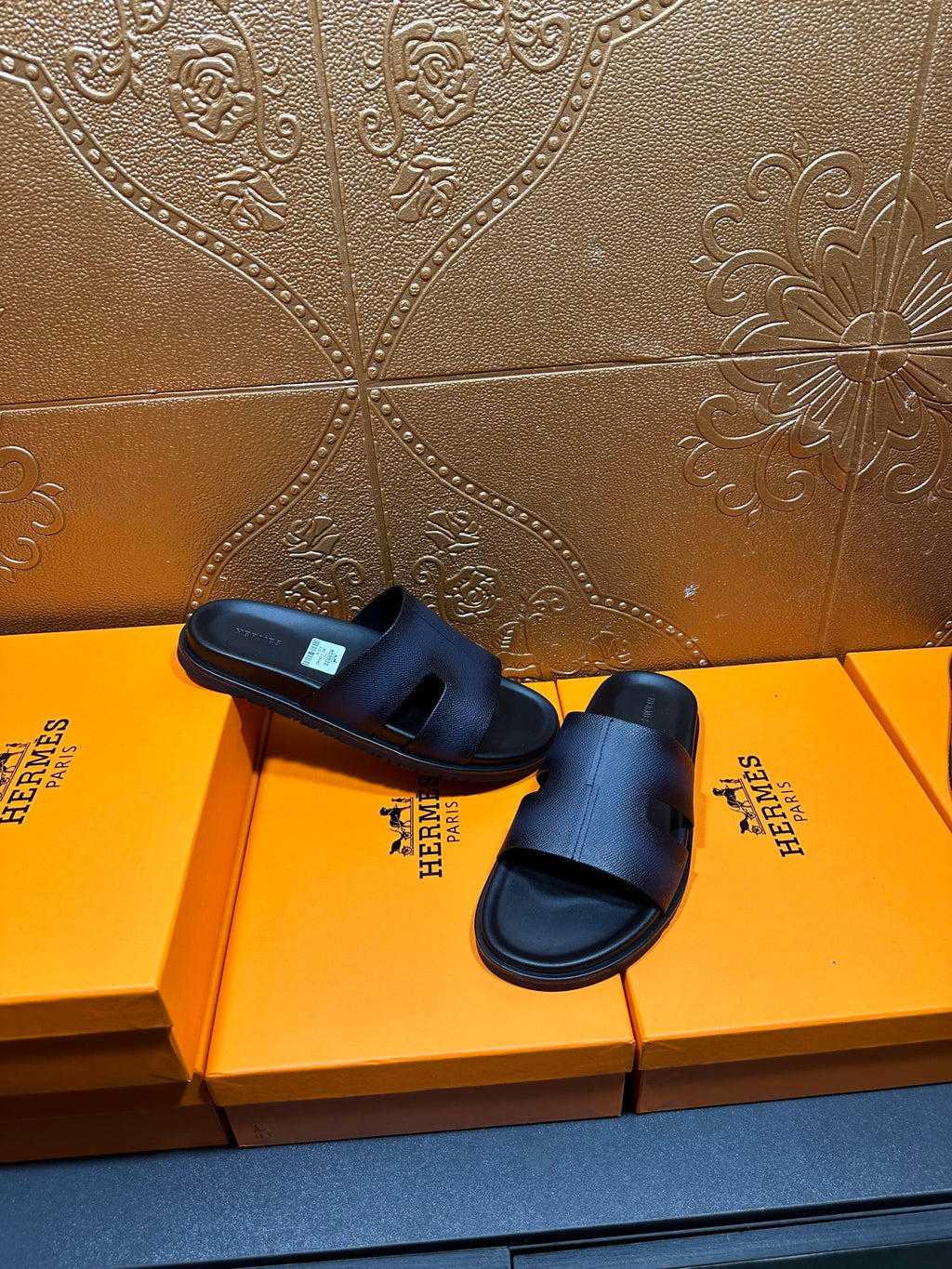 Hermes dark leather slide sandals with wide strap and open toe, top view