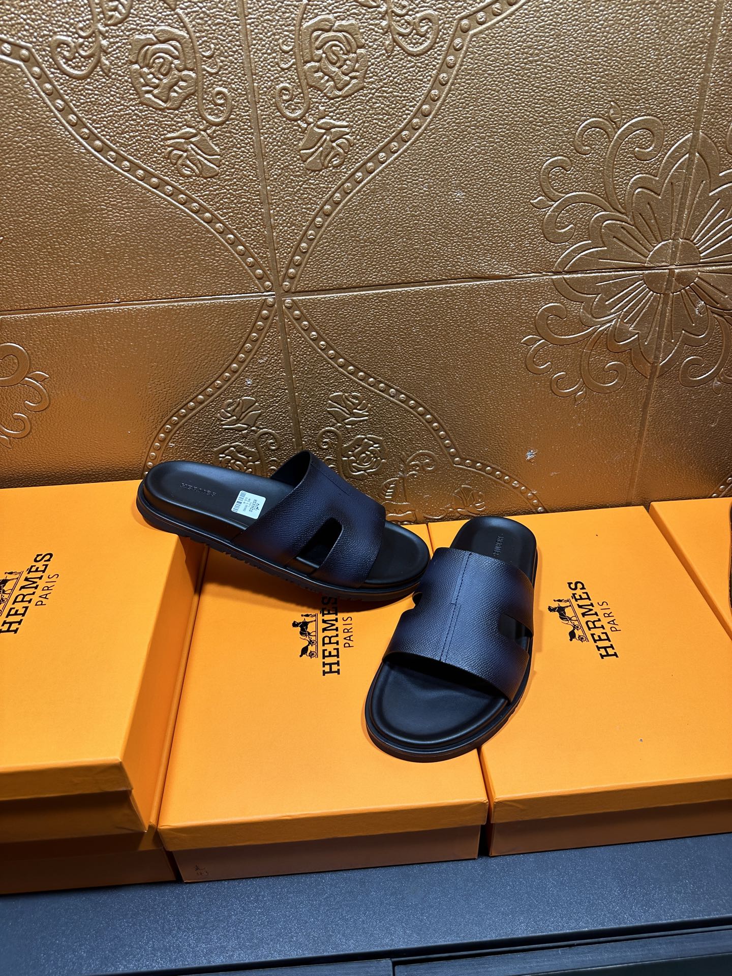 Hermes dark leather slide sandals with wide strap and open toe, top view