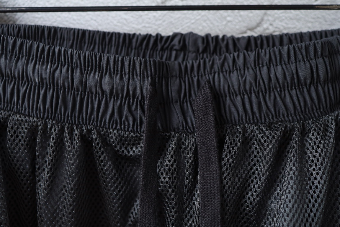 Dark elastic waistband with mesh-like panel detail on pants