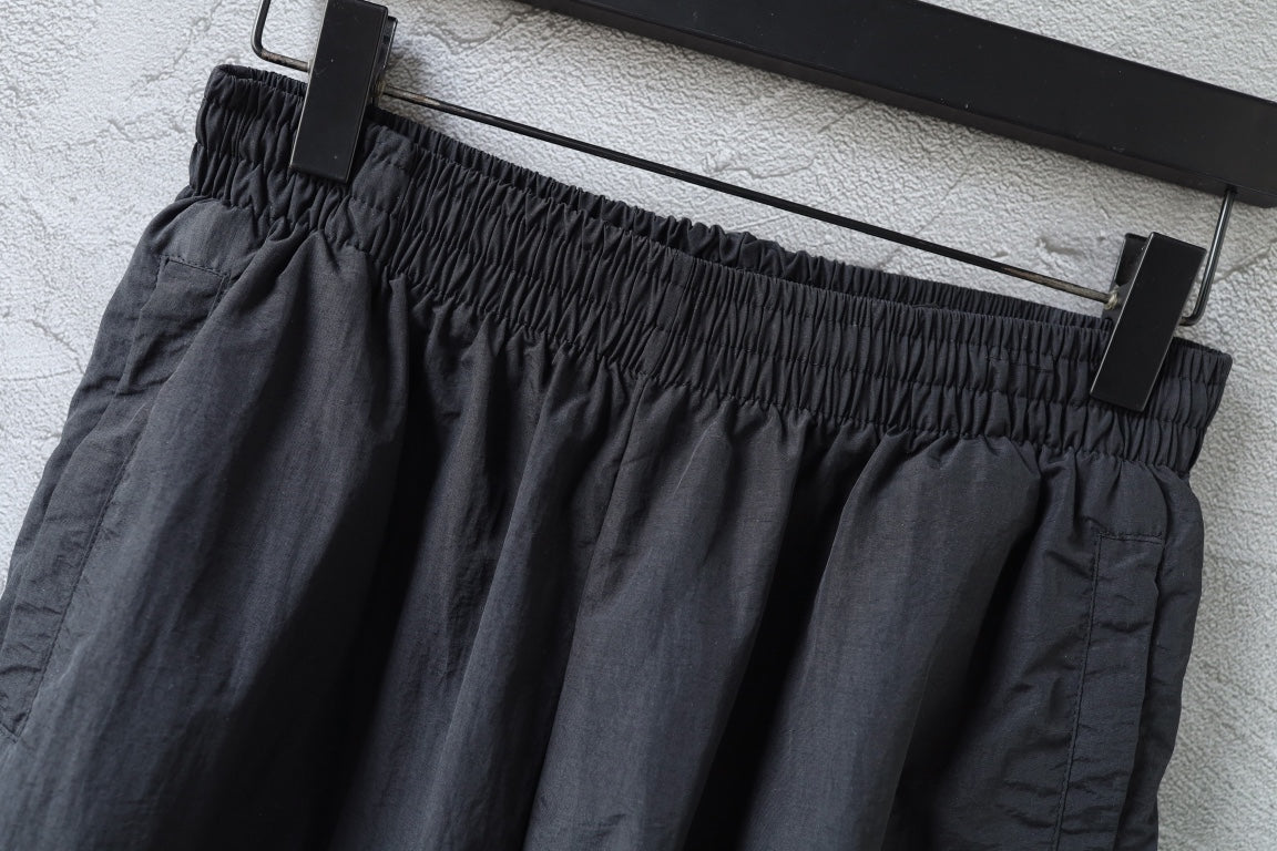 Dark gathered waistband pants with belt loops and front seam detail