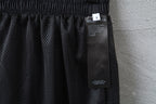 Dark pants with mesh-like fabric panel and attached size label