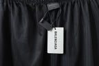 Black perforated mesh pants with hanging Balenciaga logo tag
