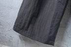 Dark pants hem with straight leg opening and visible stitching