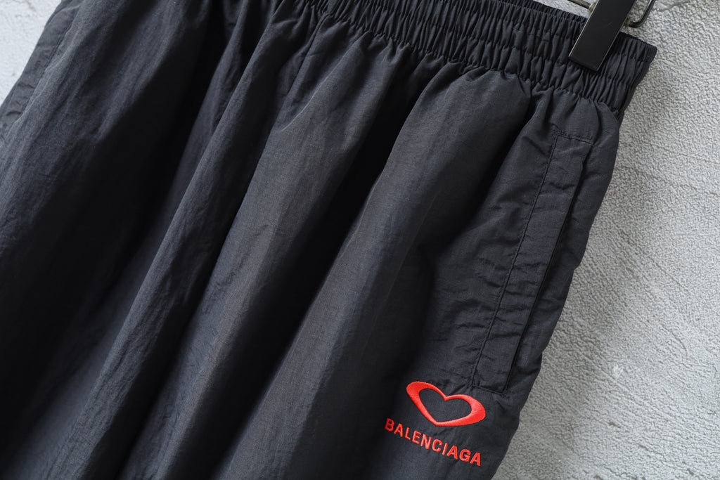Black wide-leg pants with elastic waist and red heart BALENCIAGA logo