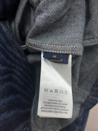 Blue jacket care tag with size 48 and washing instructions
