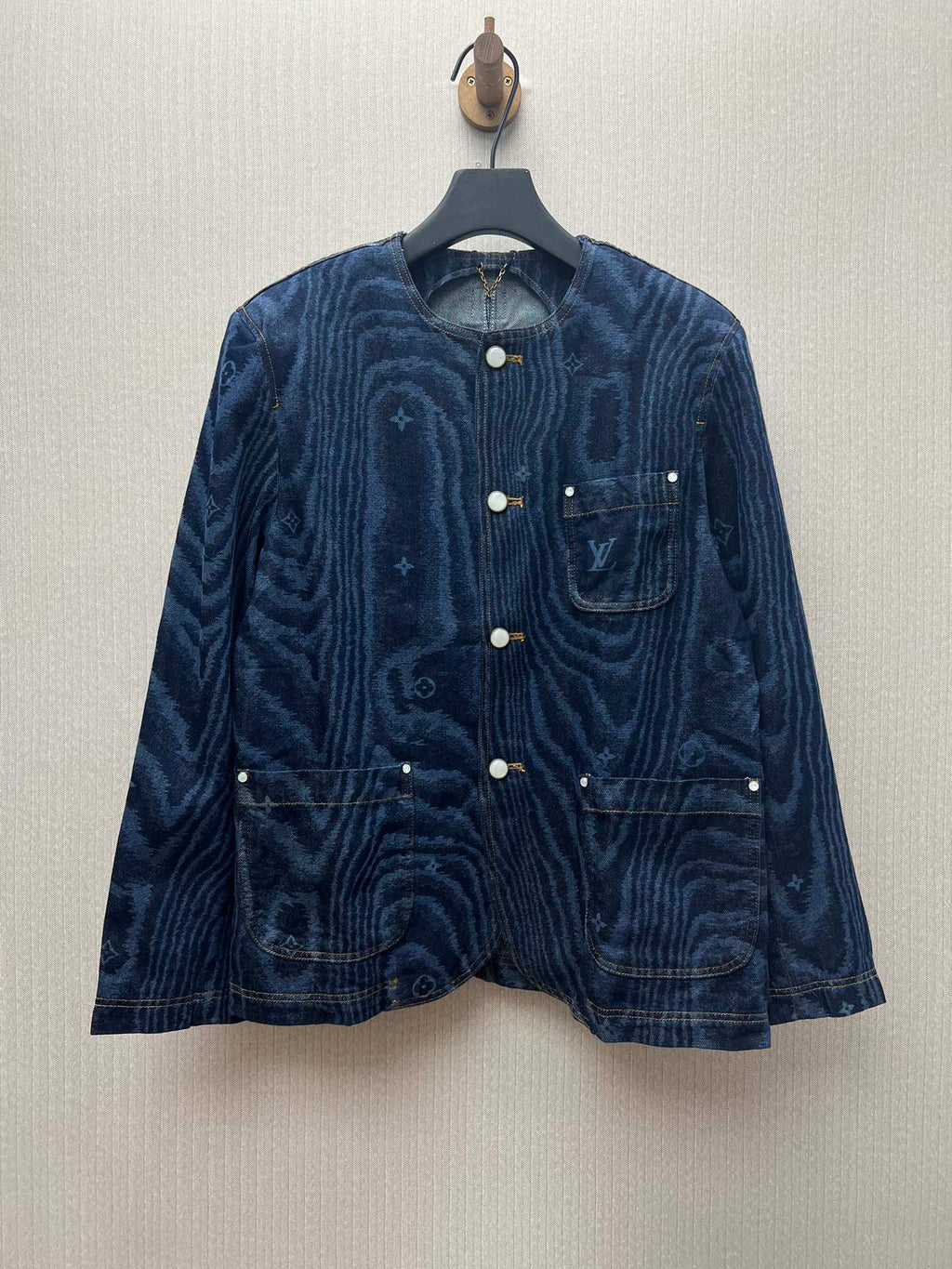 Long-sleeve blue denim jacket with button front and chest flap pockets