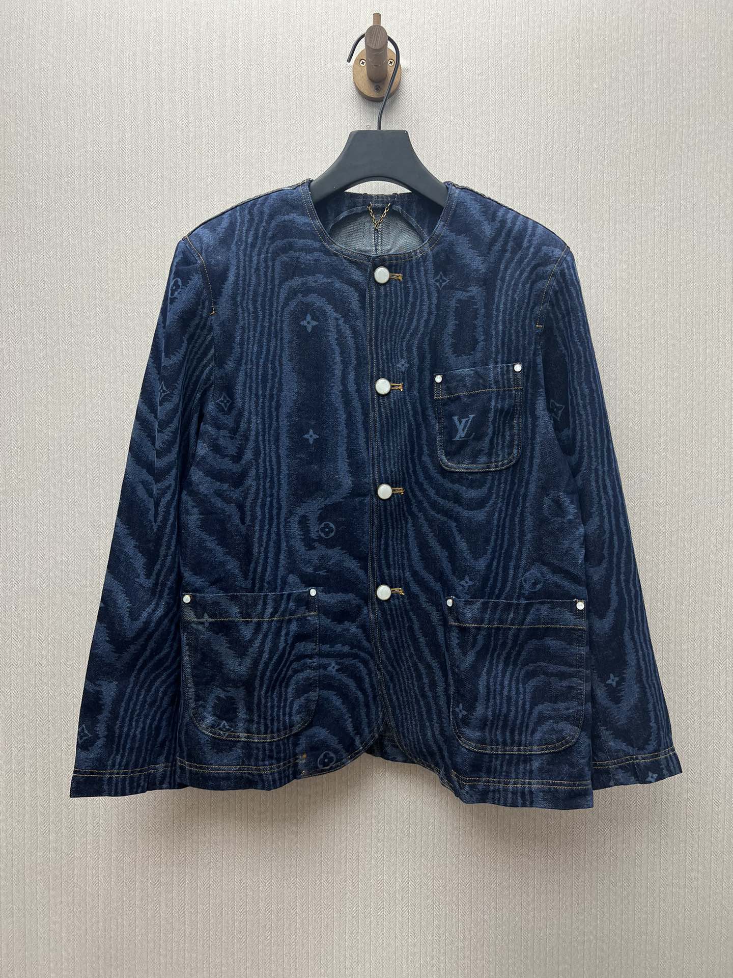 Long-sleeve blue denim jacket with button front and chest flap pockets
