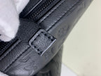 Louis Vuitton bag zipper close-up with leather pull tab and embossed pattern