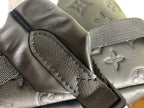 Louis Vuitton bag leather flap edge with stitched detail and strap attachment