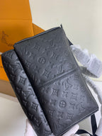 Louis Vuitton monogram backpack with front panel seam and adjustable strap, dark embossed.