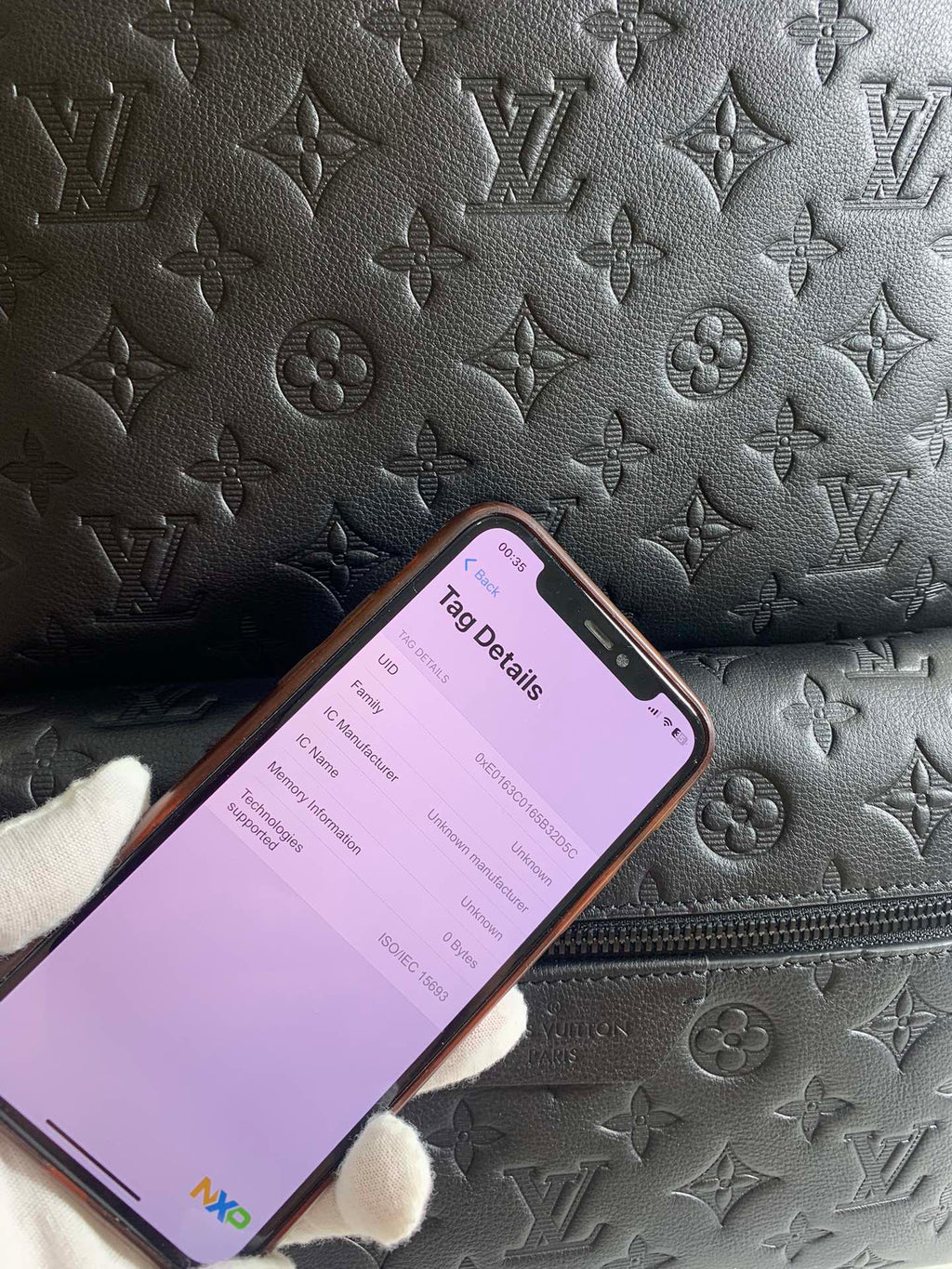 Louis Vuitton bag exterior with all-over monogram embossing and phone tag app
