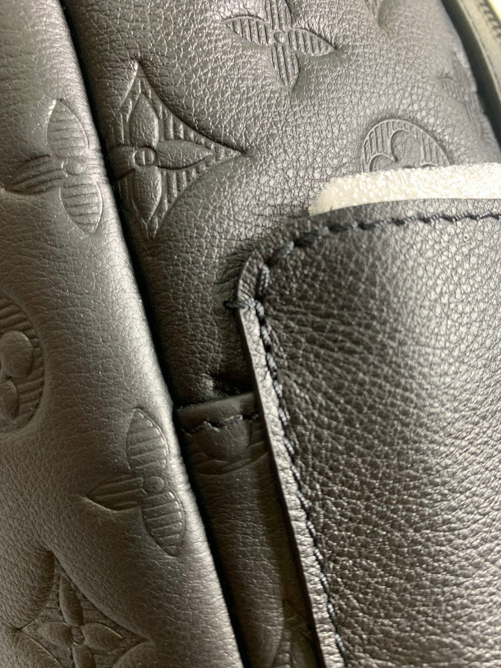 Louis Vuitton bag leather pocket detail with contrast stitching and zipper edge