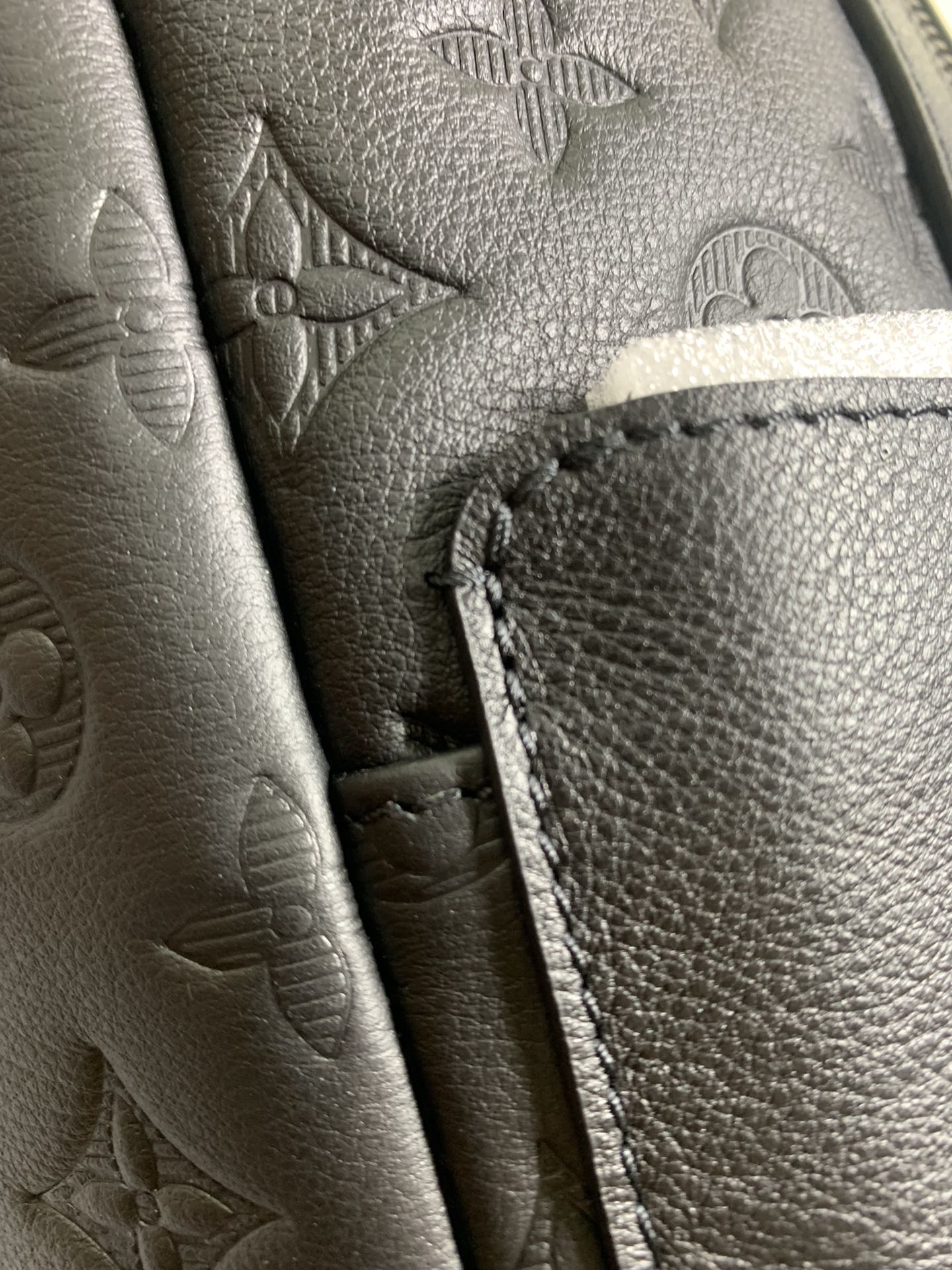 Louis Vuitton bag leather pocket detail with contrast stitching and zipper edge