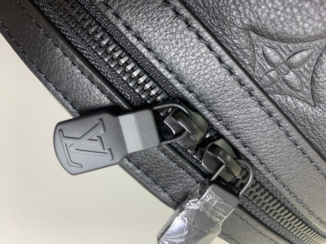 Louis Vuitton bag zipper pull with leather tab and silver metal hardware