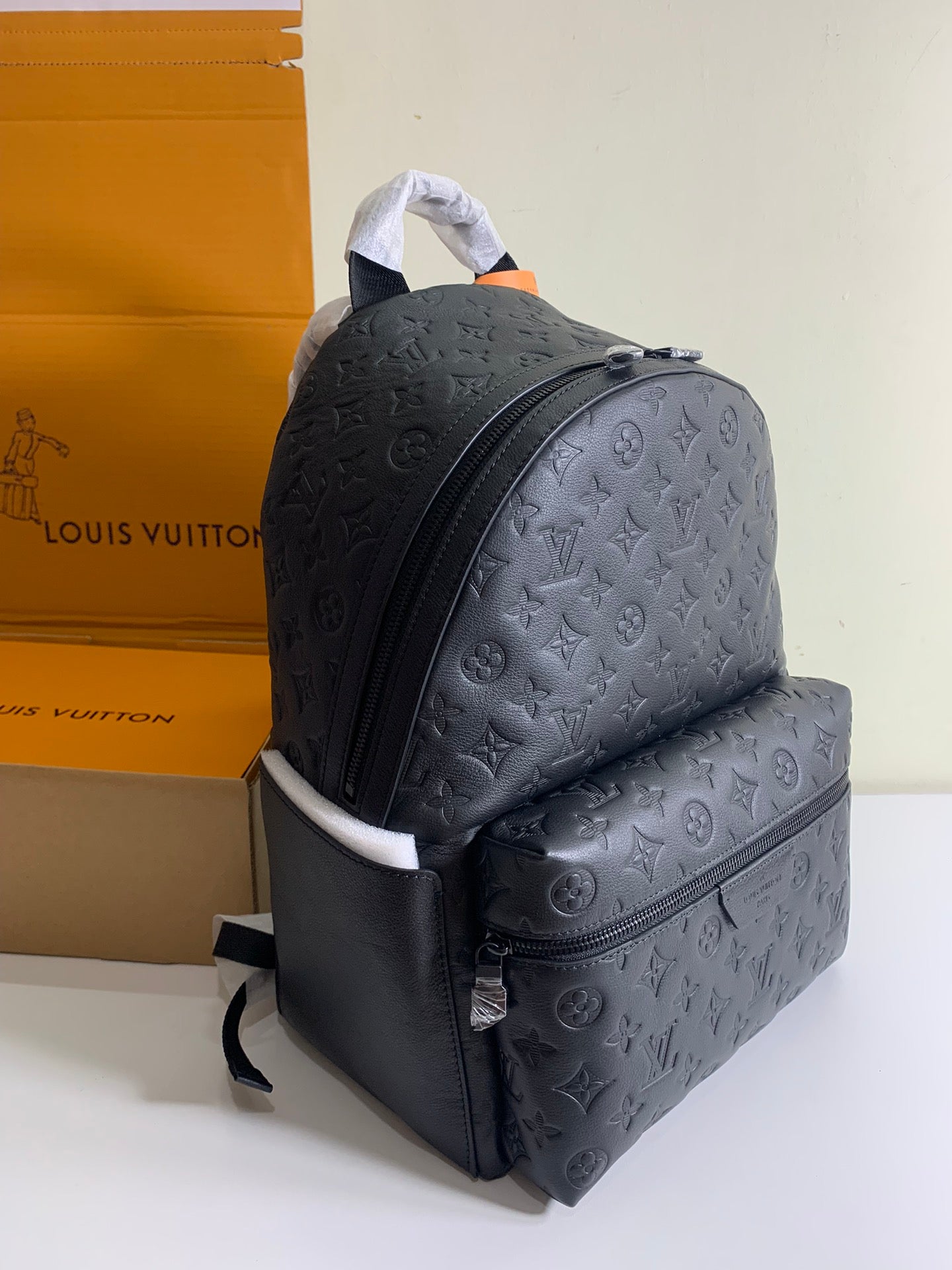 Louis Vuitton monogram backpack with side zip pocket and adjustable shoulder straps, dark.