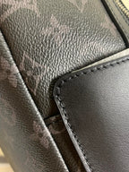 Monogram backpack close-up of textured leather trim and stitched zipper edge