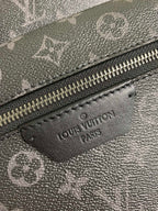 Monogram bag leather label patch near zipper with engraved Louis Vuitton text