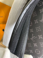 Monogram backpack close-up of perforated strap panel and dark leather trim