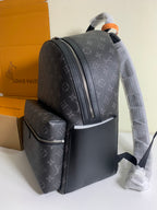 Monogram backpack with front organizer pocket and side zipper detail