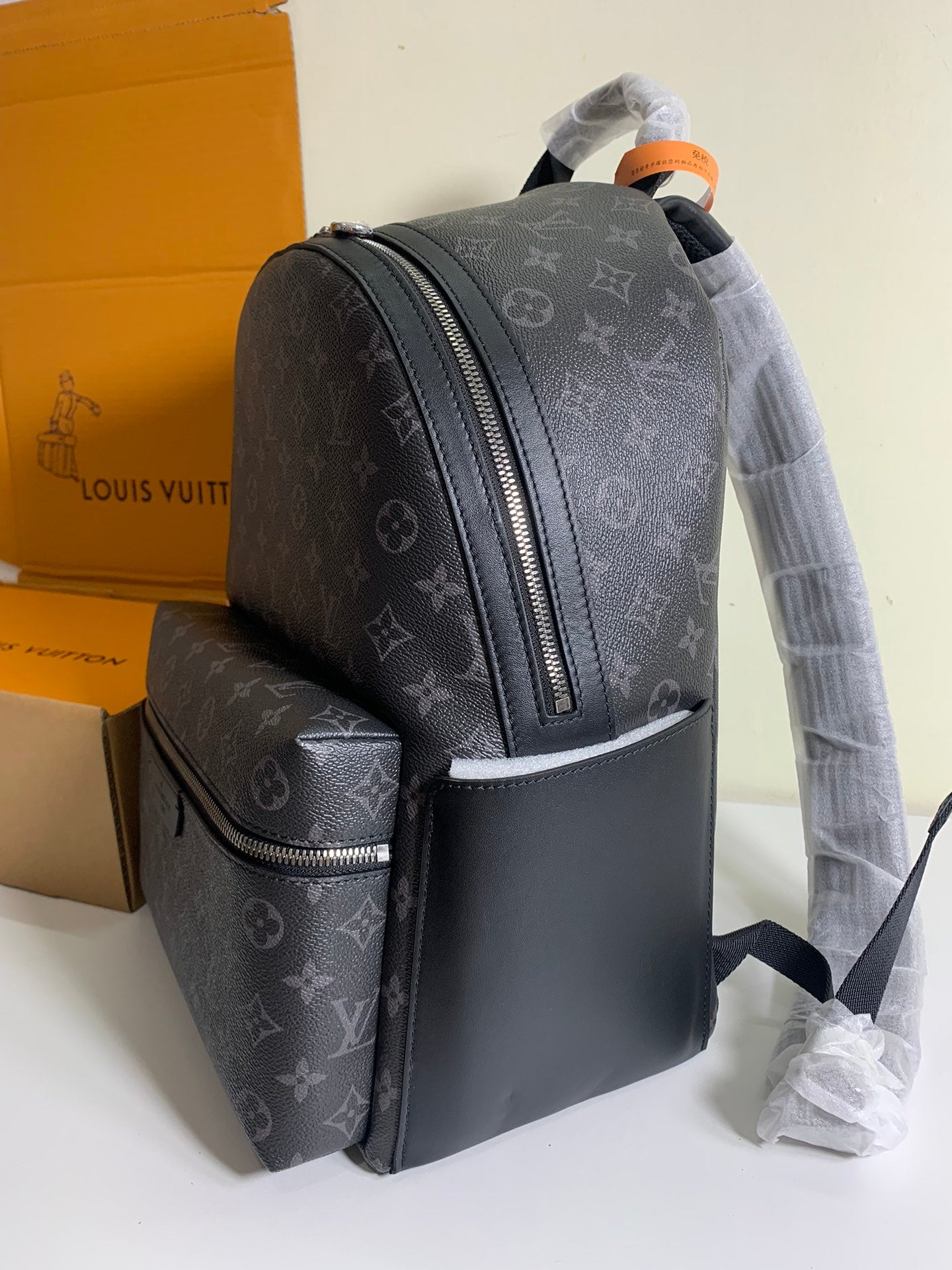 Monogram backpack with front organizer pocket and side zipper detail