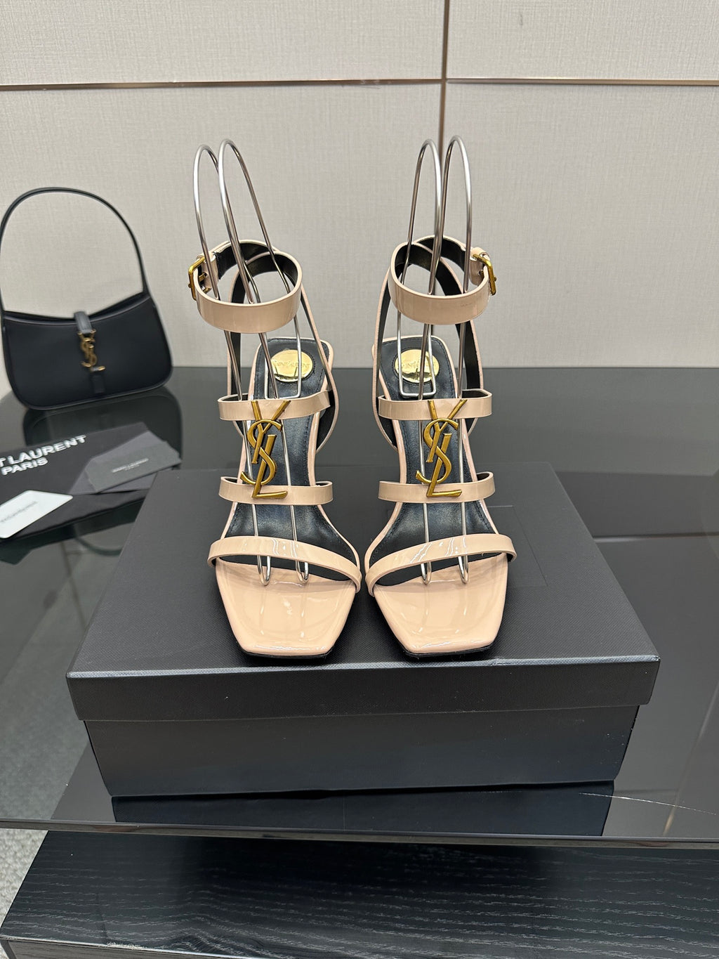 Beige strappy high-heel sandals with gold hardware and ankle slingback.