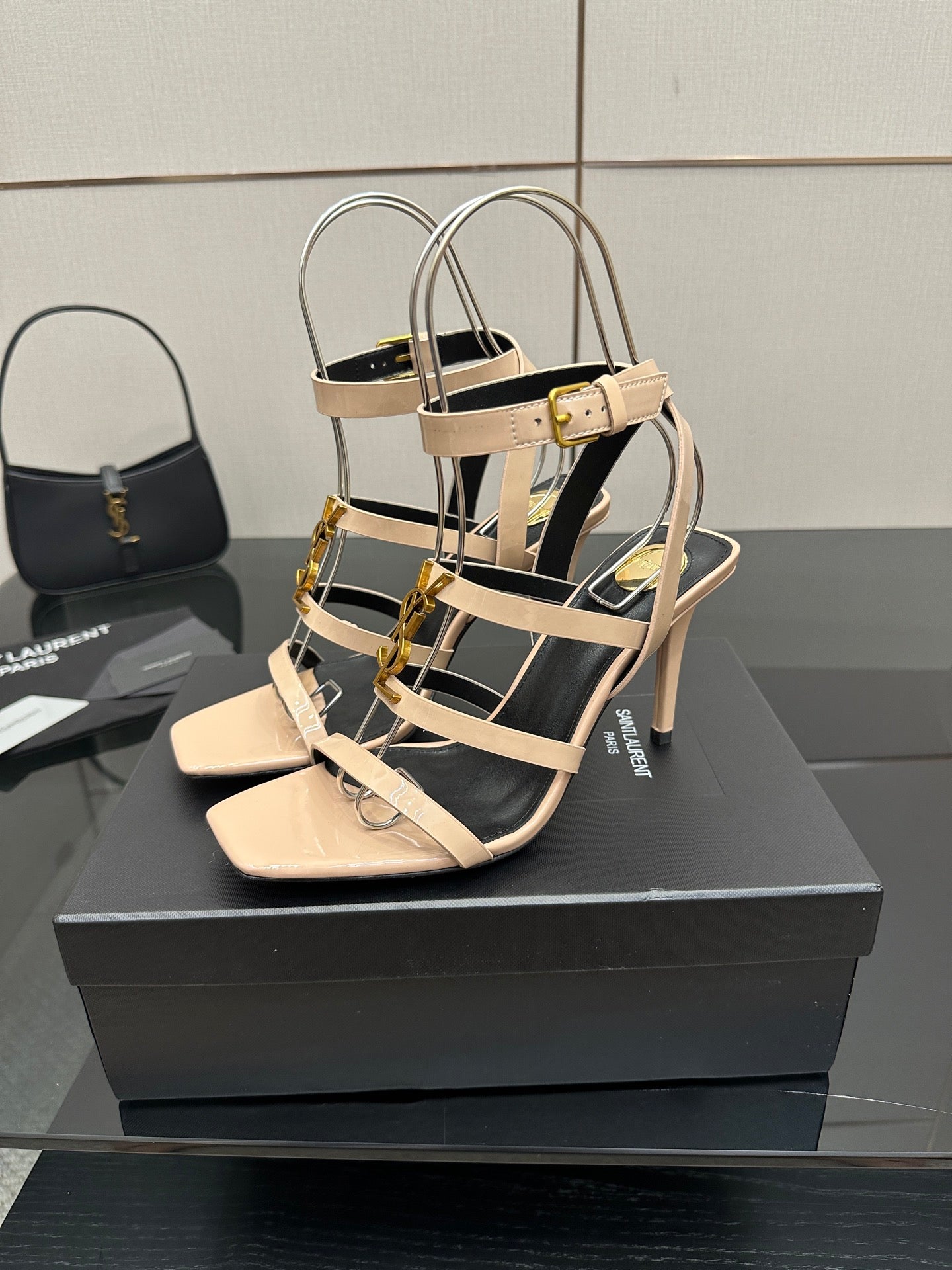 Beige strappy high-heel sandal with thin straps, gold buckles, and open toe.