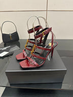 Red strappy heeled sandals with gold YSL buckle and clear sling straps