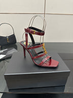 Red patent open-toe stiletto sandal with gold YSL buckle and clear straps