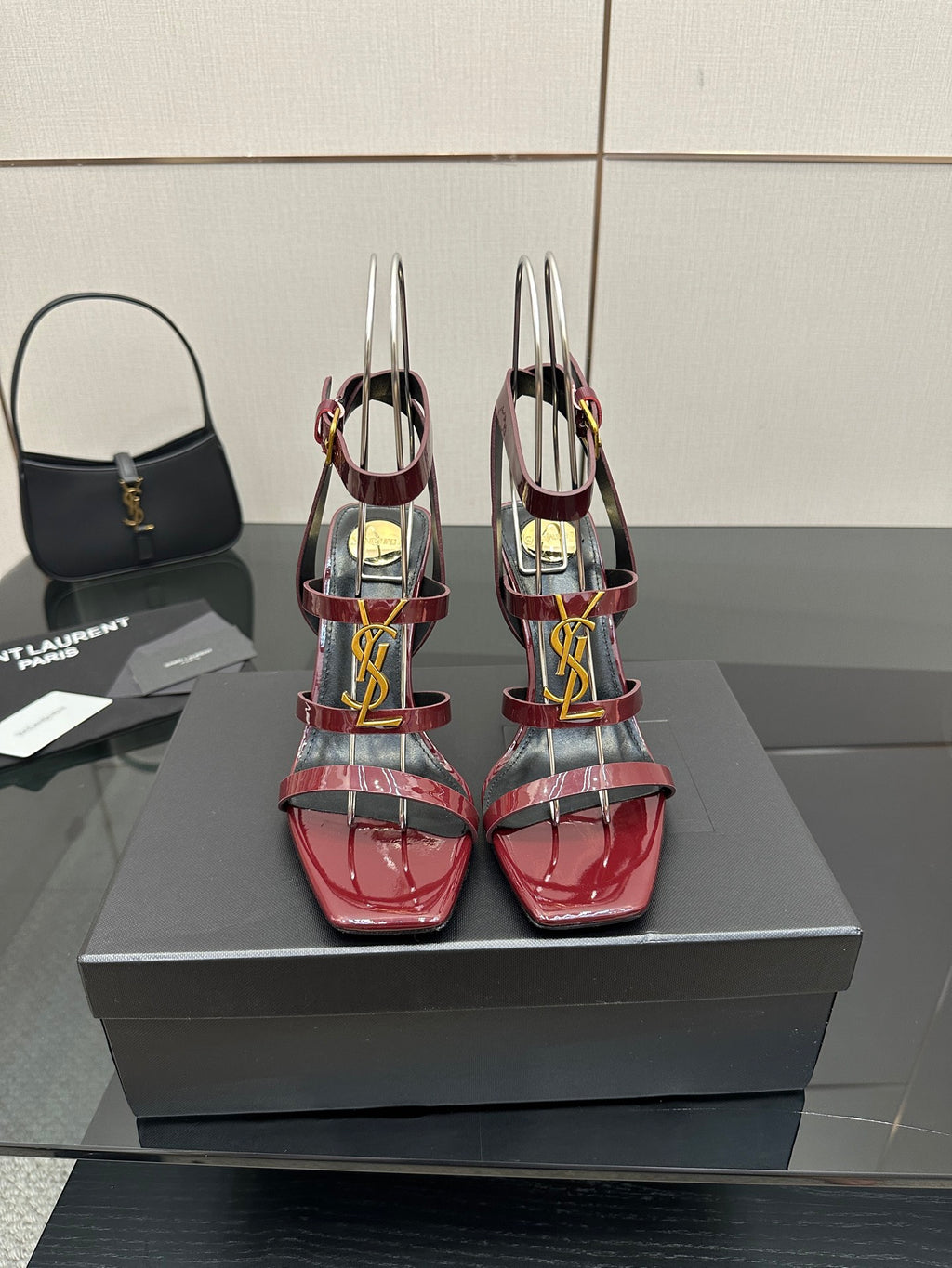 Red patent strappy high-heel sandals with gold YSL buckle and stiletto heels