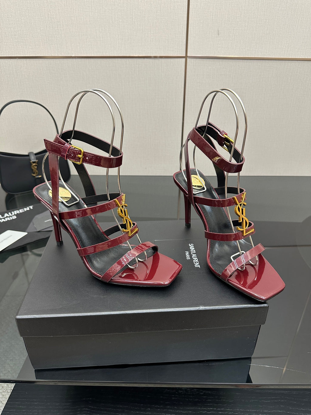 Red strappy high-heel sandals with gold YSL buckle and thin sling straps