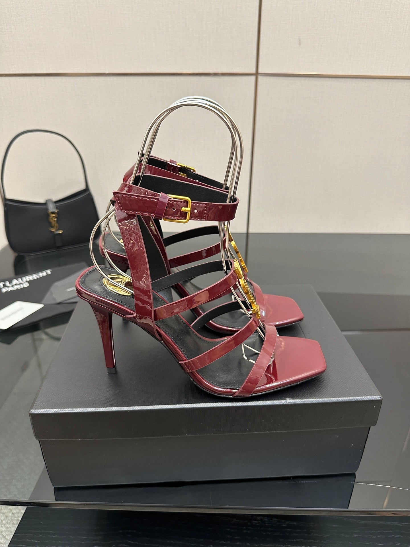 Red patent open-toe strappy sandals with gold YSL buckle and stiletto heel