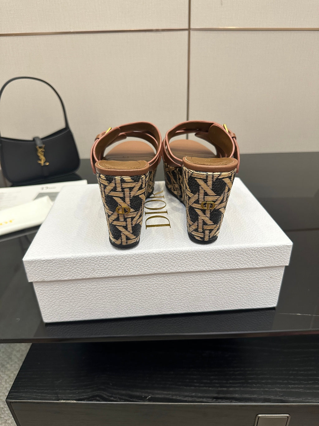 Platform sandals with tan straps and patterned heel area with gold buckles.