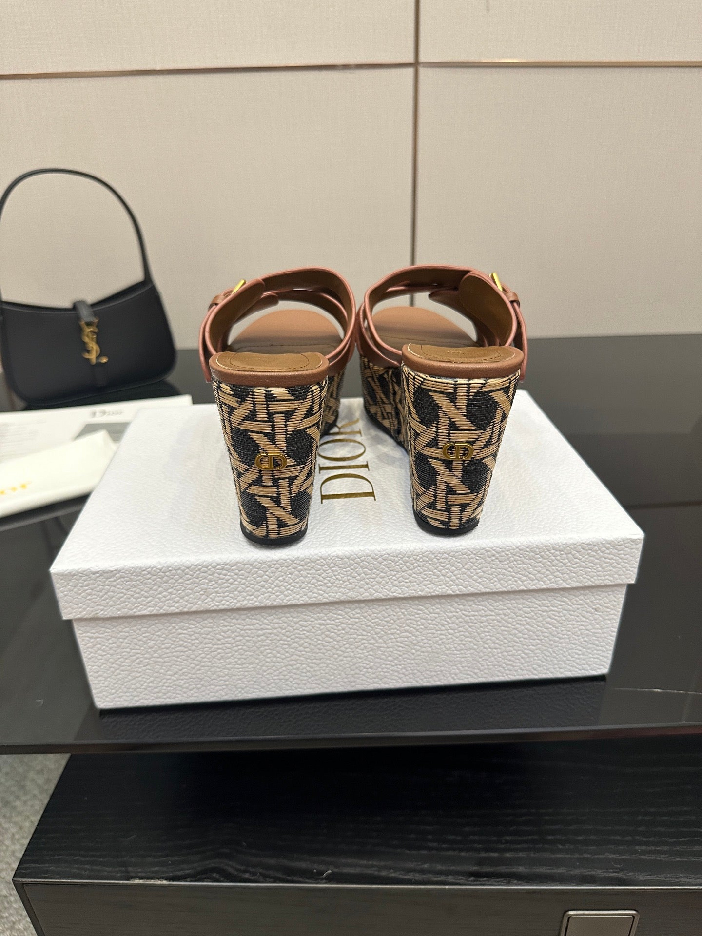 Platform sandals with tan straps and patterned heel area with gold buckles.