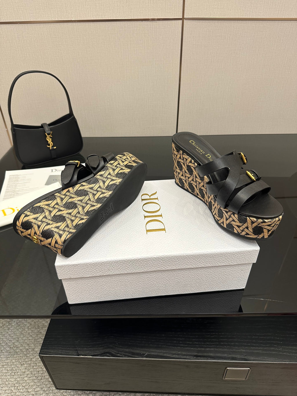 Black platform sandals with gold buckles and tan patterned wedge