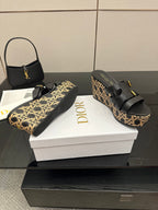 Black platform sandals with gold buckles and tan patterned wedge